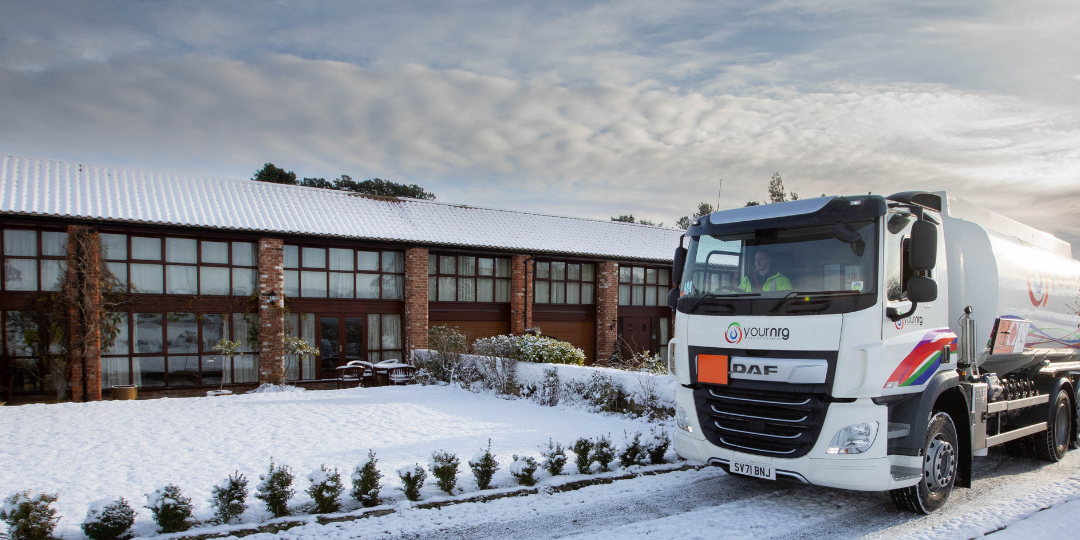 Tanker Parked in front of Homes in Snow