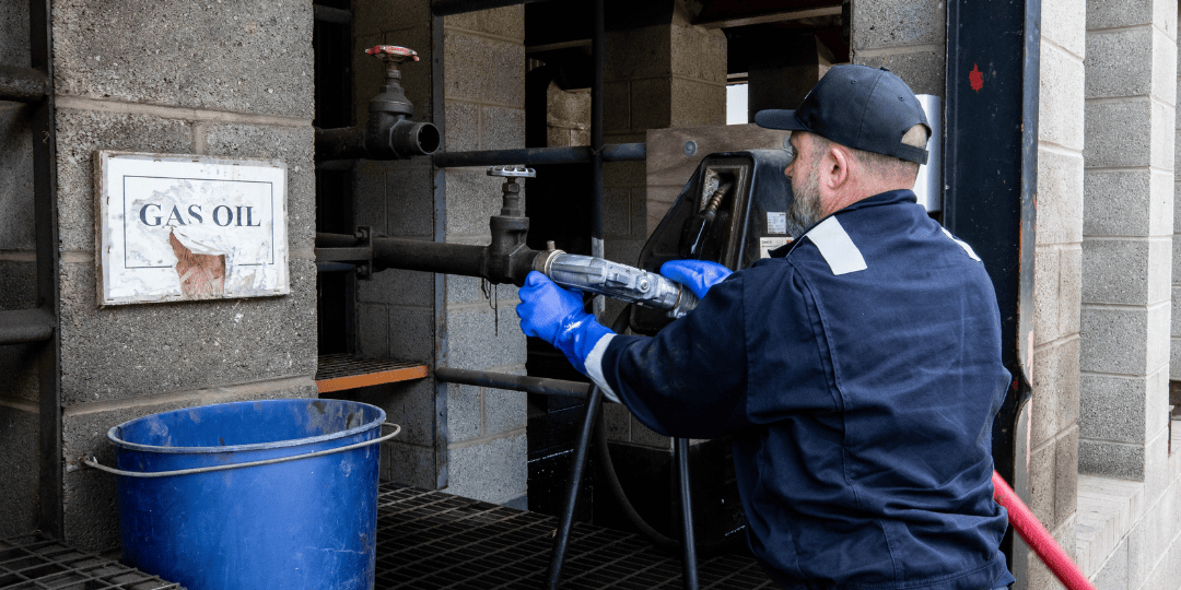 Man Fixing Pump to Pipes