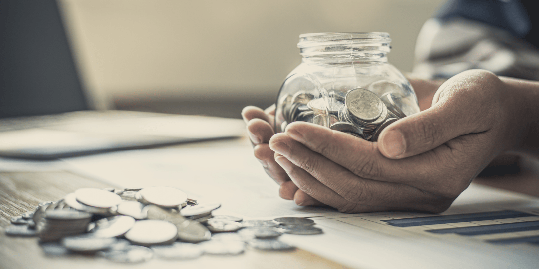 Person Holding Jar of Money